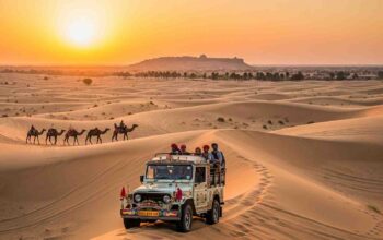 A jeep and camel caravan on golden sand dunes at sunset in the Thar Desert, Rajasthan