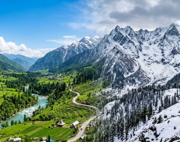 Panoramic view of lush green valleys and snow-capped mountains in Himachal Pradesh, representing the best season to visit Himachal.