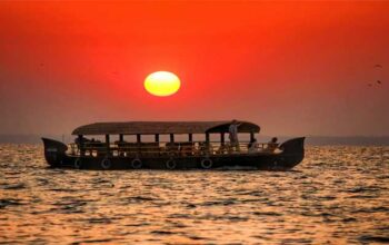 Couple on Kerala houseboat in golden evening light — best time to visit India for honeymoon