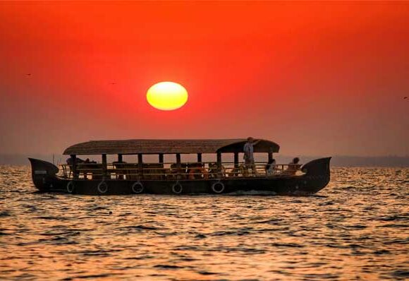 Couple on Kerala houseboat in golden evening light — best time to visit India for honeymoon