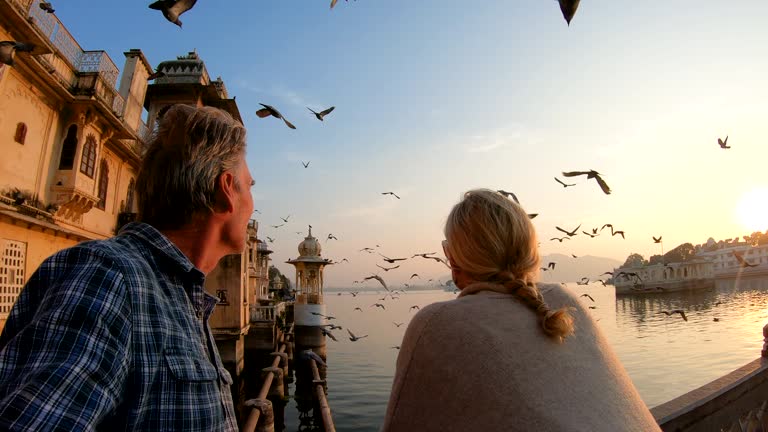 Couple exploring Rajasthan fort at sunrise in cool season clothing — India winter honeymoon packing guide