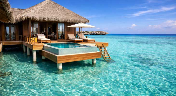 Maldives overwater villa private deck with turquoise lagoon and ocean views