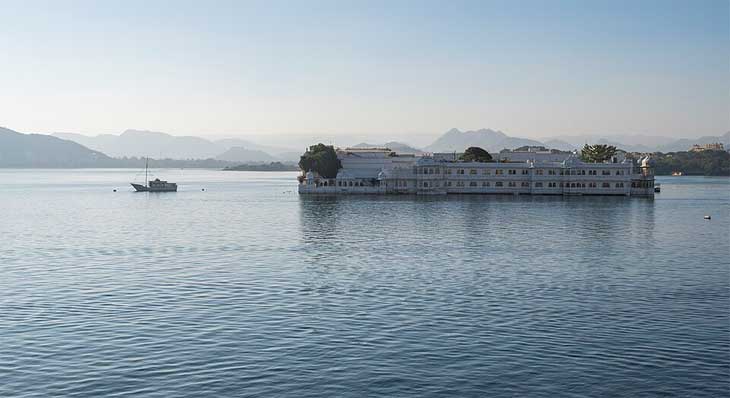Taj Lake Palace Udaipur floating on Lake Pichola at dusk — luxury honeymoon hotel in Rajasthan India