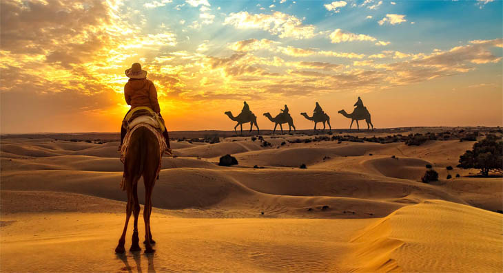 Camel caravan at sunset on Sam Sand Dunes, Jaisalmer Rajasthan — Golden Triangle Rajasthan desert extension