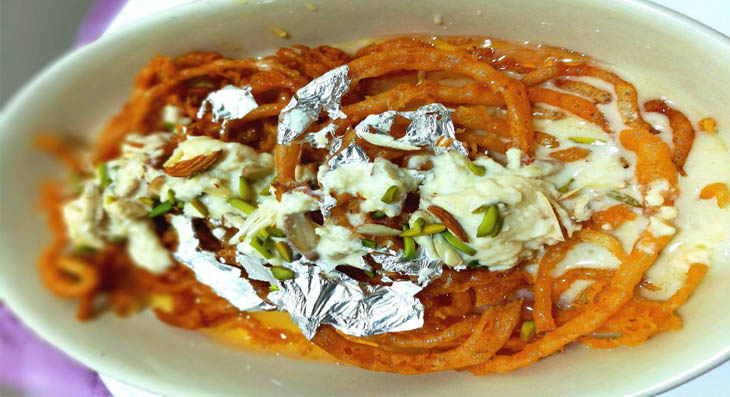 Hot crispy Jalebi served with cold thick rabri at Laxmi Misthan Bhandar, a classic Jaipur sweet breakfast