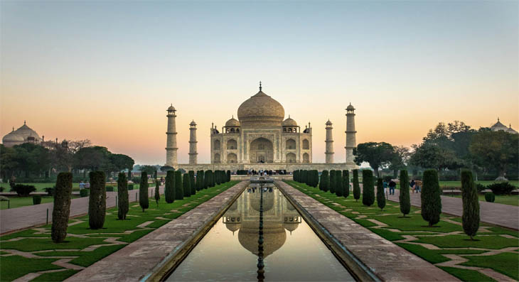 Taj Mahal at sunrise with reflection in Char Bagh pool, Agra, India — Golden Triangle tour highlight 2026