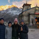 NRI family standing in front of Kedarnath temple during Char Dham Yatra 2026, Uttarakhand, India