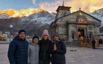 NRI family standing in front of Kedarnath temple during Char Dham Yatra 2026, Uttarakhand, India