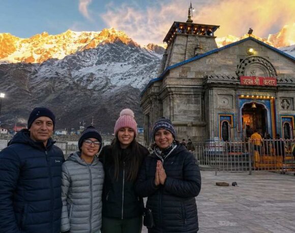 NRI family standing in front of Kedarnath temple during Char Dham Yatra 2026, Uttarakhand, India