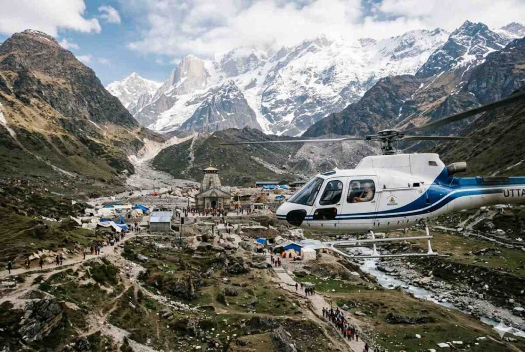 Helicopter flying over the Kedarnath valley for Char Dham helicopter yatra, an accessible option for senior NRI pilgrims