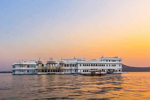 Romantic sunset view of Taj Lake Palace and Lake Pichola in Udaipur