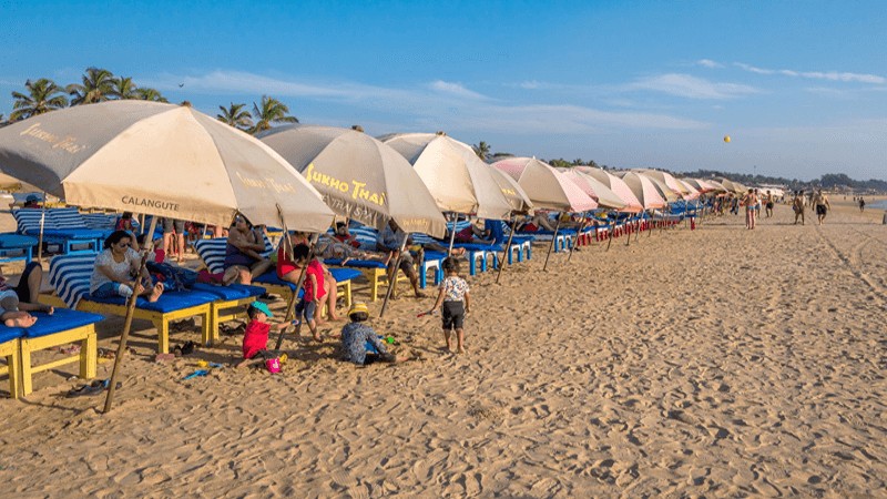 Tourists enjoying Goa beach during the winter travel season